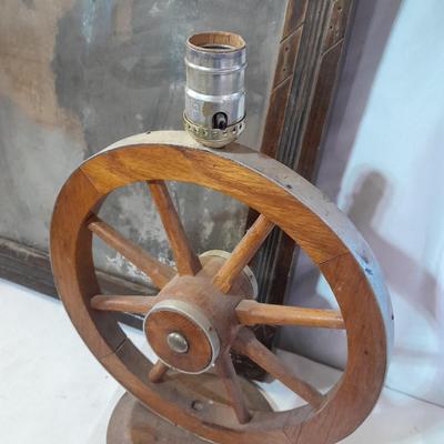 Antique picture frame with wagon wheel lamp