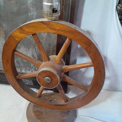 Antique picture frame with wagon wheel lamp