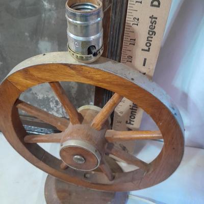 Antique picture frame with wagon wheel lamp
