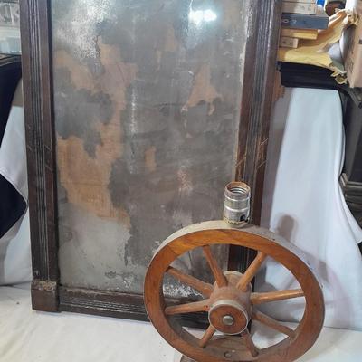 Antique picture frame with wagon wheel lamp