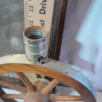 Antique picture frame with wagon wheel lamp