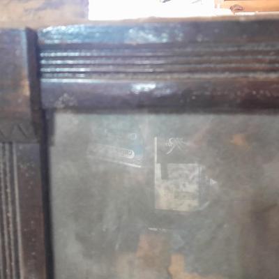 Antique picture frame with wagon wheel lamp