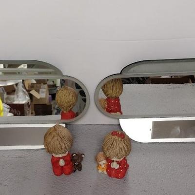 Mirrored Shelves and Praying Children Figures
