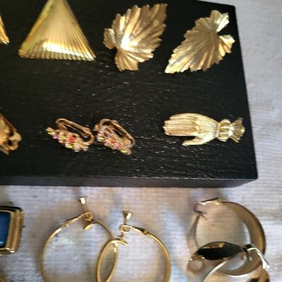 GOLD-TONE CLIP ON EARRINGS AND A HAND BROOCH