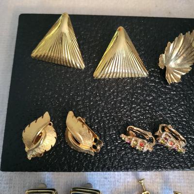 GOLD-TONE CLIP ON EARRINGS AND A HAND BROOCH