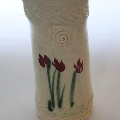 Pottery vase w/ flowers.