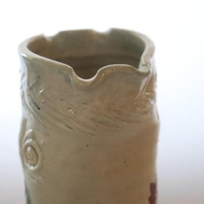 Pottery vase w/ flowers.