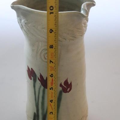 Pottery vase w/ flowers.