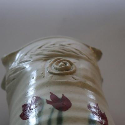 Pottery vase w/ flowers.