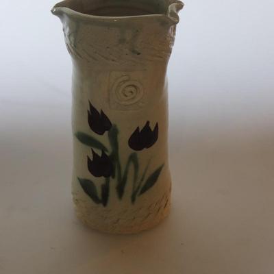 Pottery vase w/ flowers.