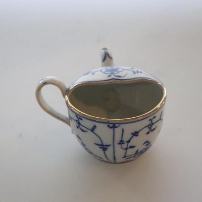 4 small Asian trinket plates with a small tea pot