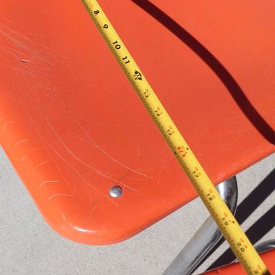 2 orange school-aged chairs