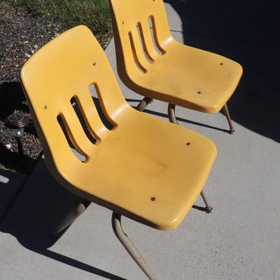 2 yellow school-aged chairs