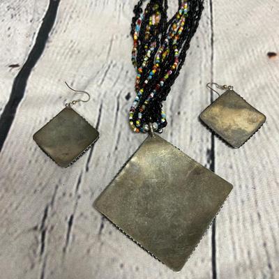 Sale Photo Thumbnail #38: this beautiful set comes with earrings and a necklace. The artist created the beaded work on metal. As you can see on the back of the piece. I’m not sure if this is silver, silver plate or what kind of metal it is. It’s slightly heavier piece. this is