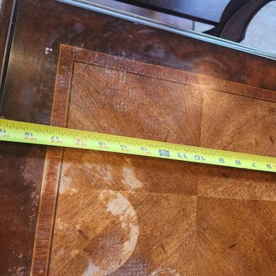 Brown furniture coffee table and two end tables.