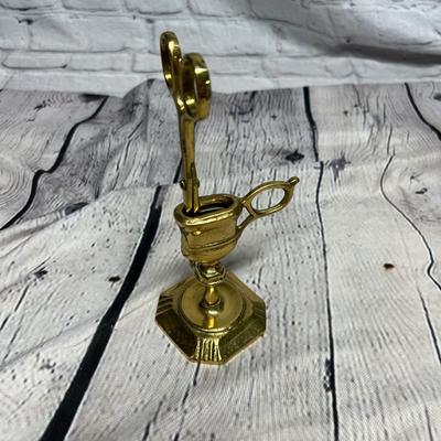 Antique candles, snuffer, and holder.