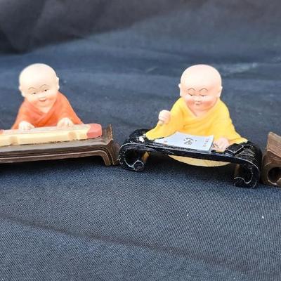 4 vtg MINIATURE ORIENTAL STATUES OF BUDDIST MONK CHILDren playing RESIN