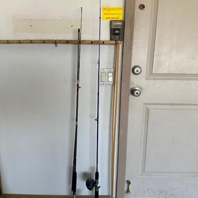2 FISHING POLES W/REELS AND A FISH GAFF