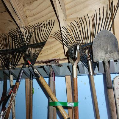Wall of Garden Yard Tools Shovels, Racks, Small hand Tools in bucket with seat, Snow Shovels