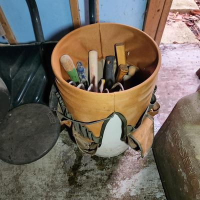 Wall of Garden Yard Tools Shovels, Racks, Small hand Tools in bucket with seat, Snow Shovels