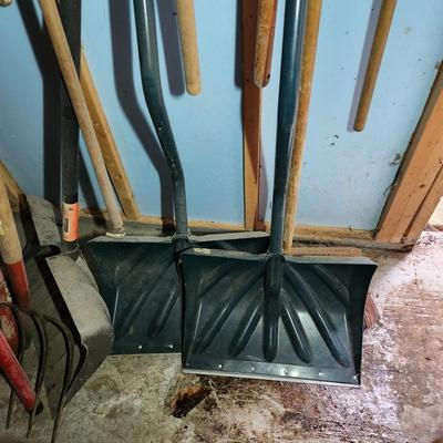 Wall of Garden Yard Tools Shovels, Racks, Small hand Tools in bucket with seat, Snow Shovels