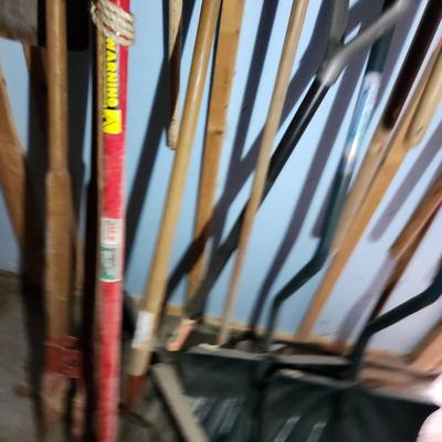 Wall of Garden Yard Tools Shovels, Racks, Small hand Tools in bucket with seat, Snow Shovels