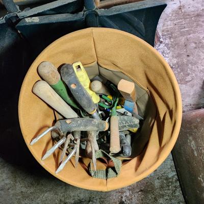 Wall of Garden Yard Tools Shovels, Racks, Small hand Tools in bucket with seat, Snow Shovels