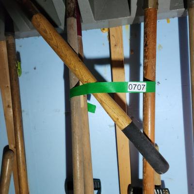 Wall of Garden Yard Tools Shovels, Racks, Small hand Tools in bucket with seat, Snow Shovels