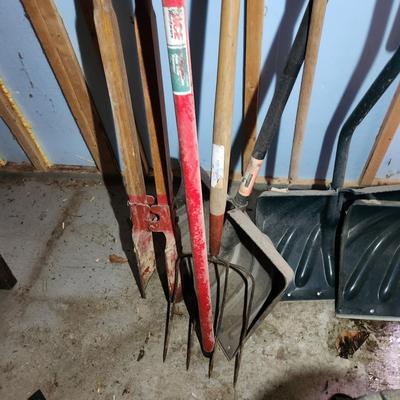Wall of Garden Yard Tools Shovels, Racks, Small hand Tools in bucket with seat, Snow Shovels