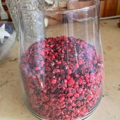 Glass vase with red fish gravel