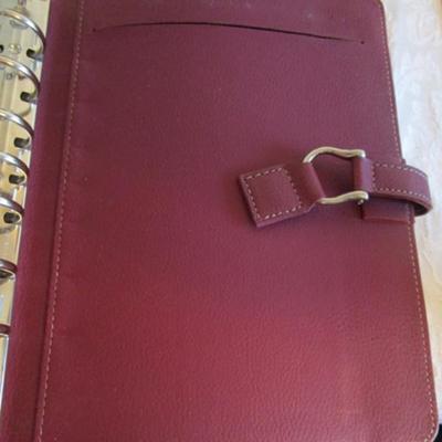 Franklin Covey binder, envelopes, 3-hole punch, business card holder, tape dispenser, pencil erasers, lists pad