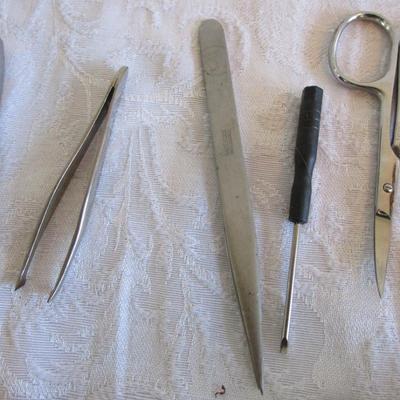 3 personal fans, emory boards, tweezers, shoe horn, extra large safety pin