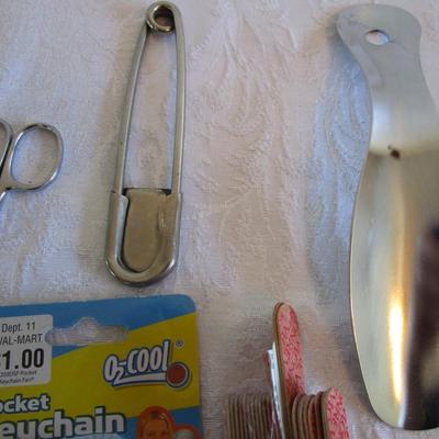 3 personal fans, emory boards, tweezers, shoe horn, extra large safety pin