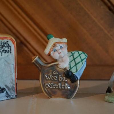 ANTIQUE GROUPING OF THREE PORCELAIN CHARACTER LIQUOR FLASKS