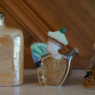 ANTIQUE GROUPING OF THREE PORCELAIN CHARACTER LIQUOR FLASKS