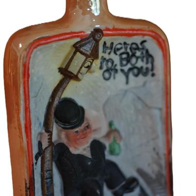 ANTIQUE GROUPING OF THREE PORCELAIN CHARACTER LIQUOR FLASKS