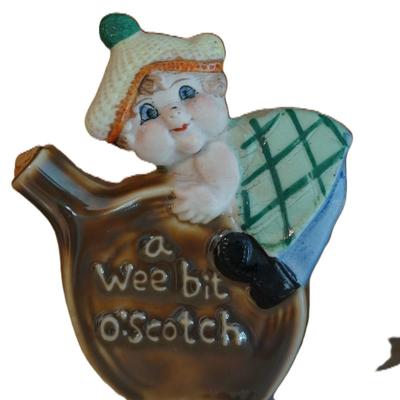 ANTIQUE GROUPING OF THREE PORCELAIN CHARACTER LIQUOR FLASKS