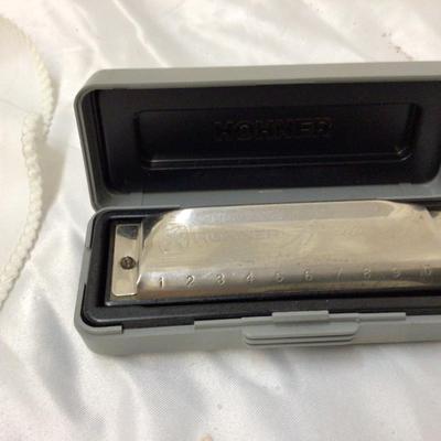 Sale Photo Thumbnail #51: This is a great Hohner harmonica in a carrying case.