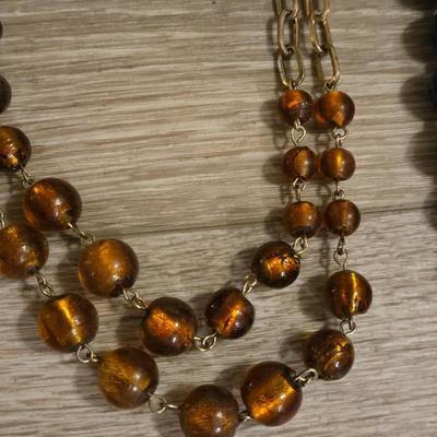 (2) Beaded Necklaces- One Black Beads and the other Amber Colored Beads
