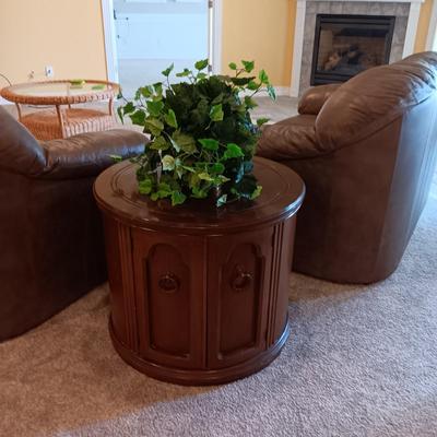 ROUND WOODEN END TABLE WITH STORAGE CABINET PLUS A FAUX PLANT