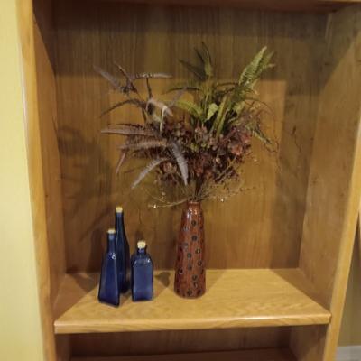 3 BLUE CORKED BOTTLES AND A CERAMIC VASE WITH FAUX FOLIAGE