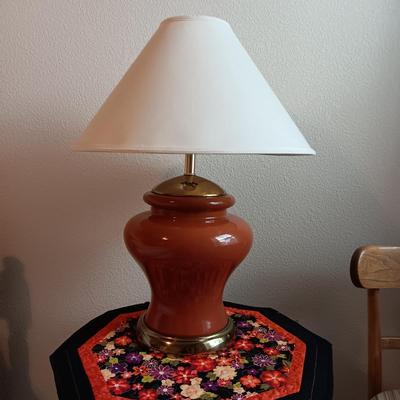 MID-CENTURY CHAIR, BURNT ORANGE LAMP, ROUND TABLE W/QUILTED PIECE
