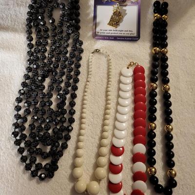 4 BEADED NECKLACES AND A CHARM