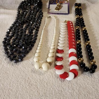 4 BEADED NECKLACES AND A CHARM