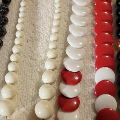4 BEADED NECKLACES AND A CHARM