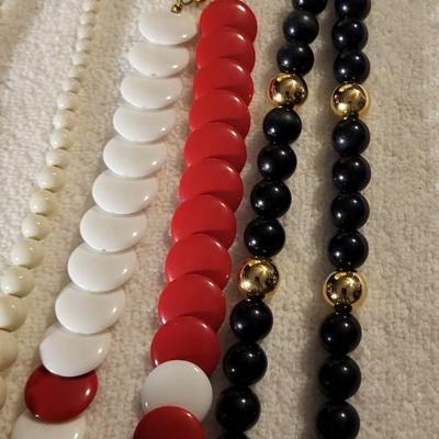 4 BEADED NECKLACES AND A CHARM