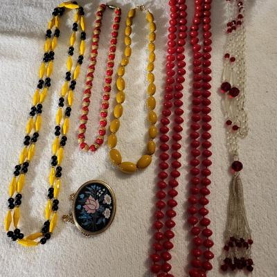 COLORFUL NECKLACES AND A LOCKET