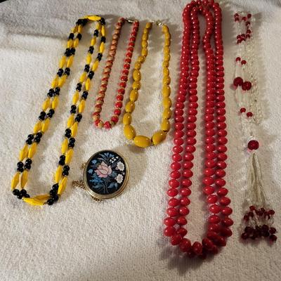 COLORFUL NECKLACES AND A LOCKET