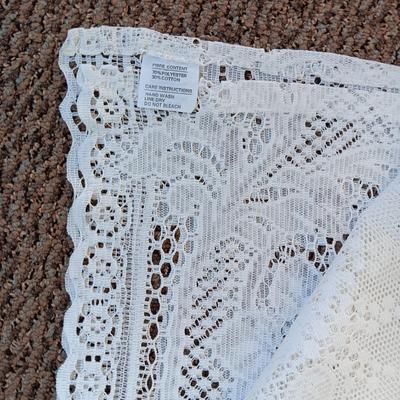 A LARGE AMOUNT OF LACEY MATERIAL AND HANDMADE DOILIES