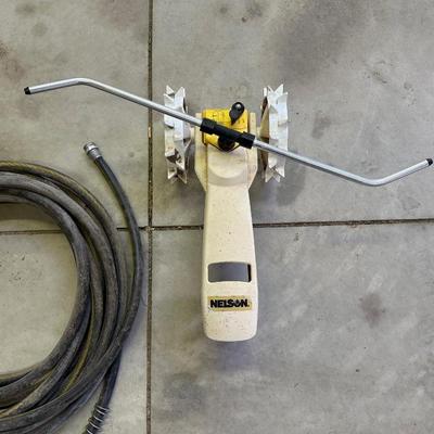 TRACTOR SPRINKLER AND A GARDEN HOSE